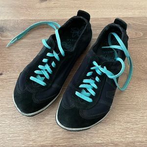 Merrell black runners with teal laces.